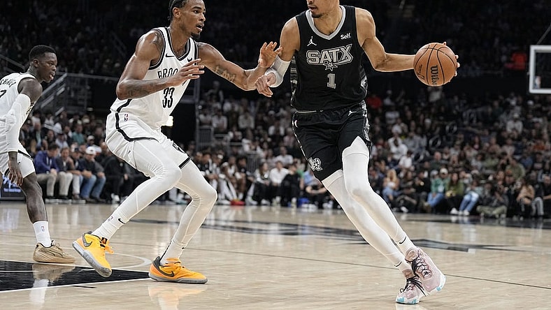 Mar 17, 2024; Austin, Texas, USA; San Antonio Spurs forward Victor Wembanyama (1) drives to the basket while defended by Brooklyn Nets center Nicolas Claxton (33) during the first half at Moody Center. Mandatory Credit: Scott Wachter-USA TODAY Sports