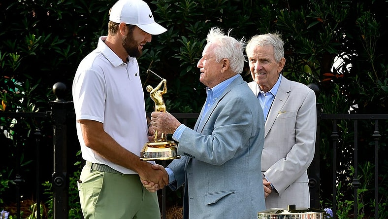 Deane Beman, the PGA Tour Commissioner to oversee the first Players Championship presents Scottie Scheffler his Gold Man tournament trophy as former Commissioner Tim Finchem looks on during the trophy ceremony following the fourth and final round of The Players Championship PGA golf tournament Sunday, March 17, 2024 at TPC Sawgrass in Ponte Vedra Beach, Fla. [Bob Self/Florida Times-Union]