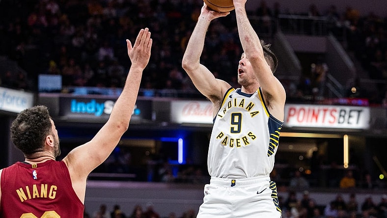 Mar 18, 2024; Indianapolis, Indiana, USA; Indiana Pacers guard T.J. McConnell (9) shoots the ball while Cleveland Cavaliers forward Georges Niang (20) defends in the first half at Gainbridge Fieldhouse. Mandatory Credit: Trevor Ruszkowski-USA TODAY Sports