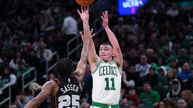 Mar 18, 2024; Boston, Massachusetts, USA; Boston Celtics guard Payton Pritchard (11) shoots the ball against Detroit Pistons guard Marcus Sasser (25) in the second quarter at TD Garden. Mandatory Credit: David Butler II-USA TODAY Sports