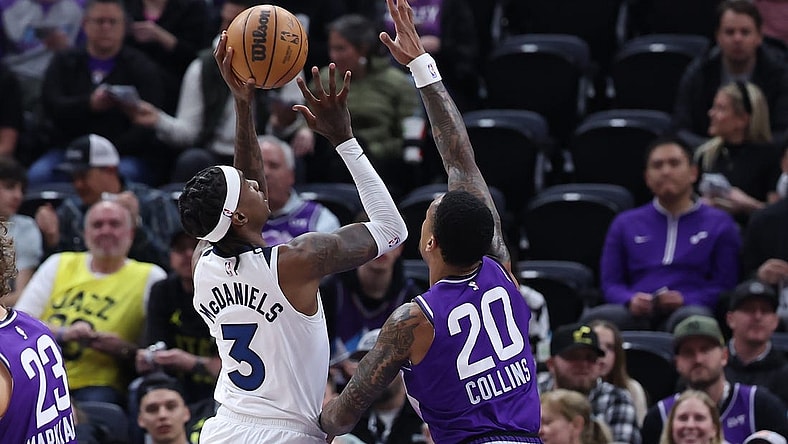 Mar 18, 2024; Salt Lake City, Utah, USA; Minnesota Timberwolves forward Jaden McDaniels (3) goes to the basket against Utah Jazz forward John Collins (20) during the first quarter at Delta Center. Mandatory Credit: Rob Gray-USA TODAY Sports