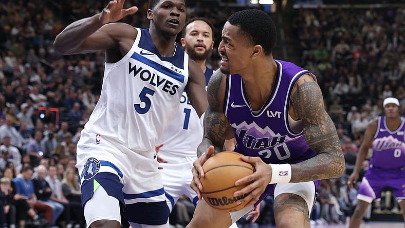 Mar 18, 2024; Salt Lake City, Utah, USA; Utah Jazz forward John Collins (20) goes to the basket against Minnesota Timberwolves guard Anthony Edwards (5) during the second quarter at Delta Center. Mandatory Credit: Rob Gray-USA TODAY Sports