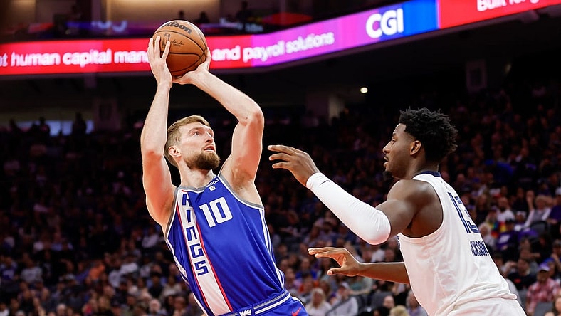 Mar 18, 2024; Sacramento, California, USA; Sacramento Kings forward Domantas Sabonis (10) shoots the ball against Memphis Grizzlies forward Jaren Jackson Jr. (13) during the first quarter at Golden 1 Center. Mandatory Credit: Sergio Estrada-USA TODAY Sports