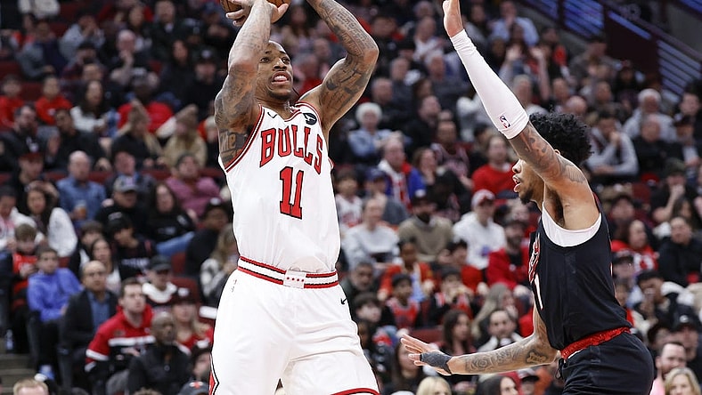 Mar 18, 2024; Chicago, Illinois, USA; Chicago Bulls forward DeMar DeRozan (11) shoots against Portland Trail Blazers guard Anfernee Simons (1) during the first half at United Center. Mandatory Credit: Kamil Krzaczynski-USA TODAY Sports