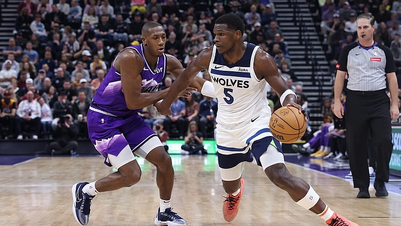 Mar 18, 2024; Salt Lake City, Utah, USA; Minnesota Timberwolves guard Anthony Edwards (5) drives against Utah Jazz guard Kris Dunn (11) during the third quarter at Delta Center. Mandatory Credit: Rob Gray-USA TODAY Sports