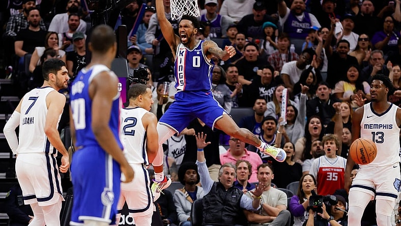 Mar 18, 2024; Sacramento, California, USA; Sacramento Kings guard Malik Monk (0) dunks the ball during the fourth quarter against the Memphis Grizzlies at Golden 1 Center. Mandatory Credit: Sergio Estrada-USA TODAY Sports