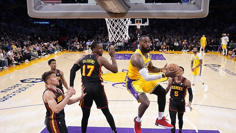 Mar 18, 2024; Los Angeles, California, USA; Los Angeles Lakers forward LeBron James (23) shoots the ball against Atlanta Hawks forward Onyeka Okongwu (17) in the second half at Crypto.com Arena. Mandatory Credit: Kirby Lee-USA TODAY Sports