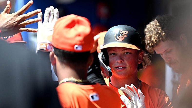 Mar 19, 2024; Dunedin, Florida, USA; Baltimore Orioles second baseman Jackson Holliday (87) celebrates with his teammates after scoring a run in the first inning of the spring training game against the Toronto Blue Jays at TD Ballpark. Mandatory Credit: Jonathan Dyer-USA TODAY Sports