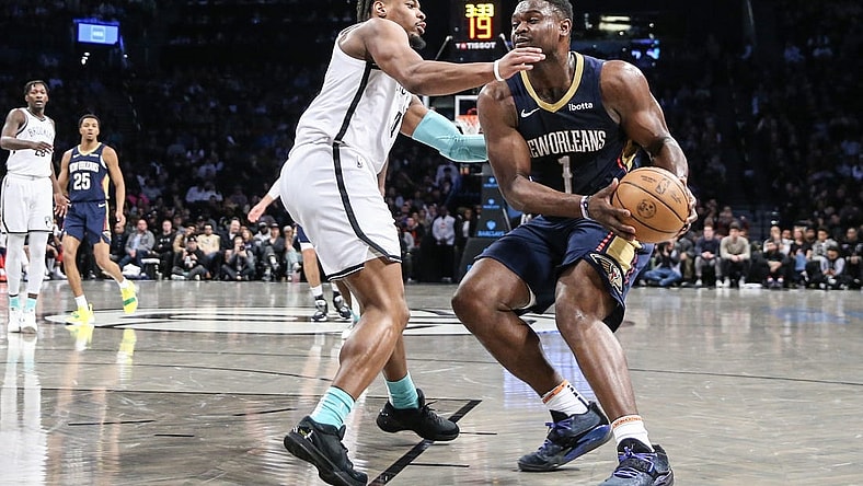 Mar 19, 2024; Brooklyn, New York, USA;  New Orleans Pelicans forward Zion Williamson (1) looks to drive past Brooklyn Nets guard Dennis Smith Jr. (4) in the second quarter at Barclays Center. Mandatory Credit: Wendell Cruz-USA TODAY Sports