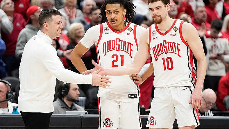 Mar 19, 2024; Columbus, OH, USA; Ohio State Buckeyes head coach Jake Diebler high fives Ohio State Buckeyes forward Jamison Battle (10) and forward Devin Royal (21) during the second half of the NIT basketball game against the Cornell Big Red at Value City Arena. Ohio State won 88-83.