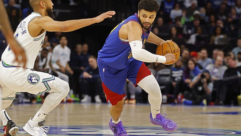 Mar 19, 2024; Minneapolis, Minnesota, USA; Denver Nuggets guard Jamal Murray (27) works around Minnesota Timberwolves guard Jordan McLaughlin (6) in the second quarter at Target Center. Mandatory Credit: Bruce Kluckhohn-USA TODAY Sports
