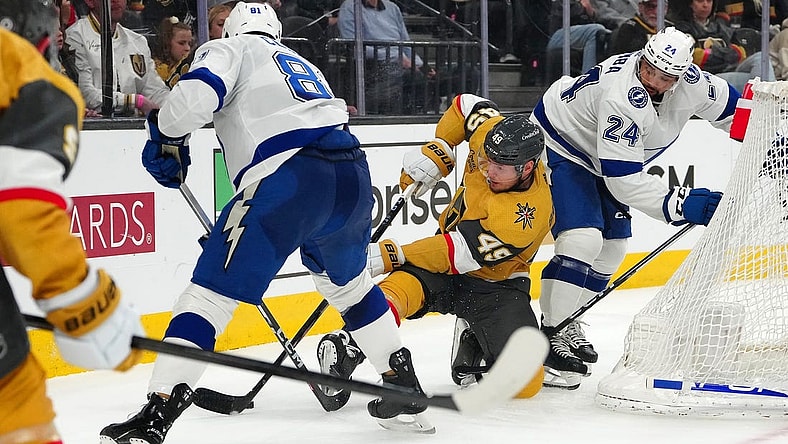 Mar 19, 2024; Las Vegas, Nevada, USA; Vegas Golden Knights center Ivan Barbashev (49) attempts to control the puck between Tampa Bay Lightning defenseman Erik Cernak (81) and Tampa Bay Lightning defenseman Matt Dumba (24) during the second period at T-Mobile Arena. Mandatory Credit: Stephen R. Sylvanie-USA TODAY Sports