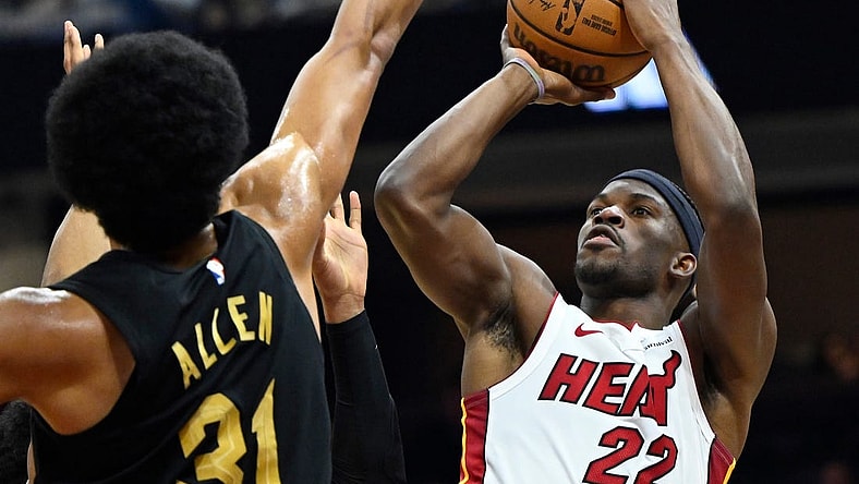 Mar 20, 2024; Cleveland, Ohio, USA; Miami Heat forward Jimmy Butler (22) shoots beside Cleveland Cavaliers center Jarrett Allen (31) in the second quarter at Rocket Mortgage FieldHouse. Mandatory Credit: David Richard-USA TODAY Sports