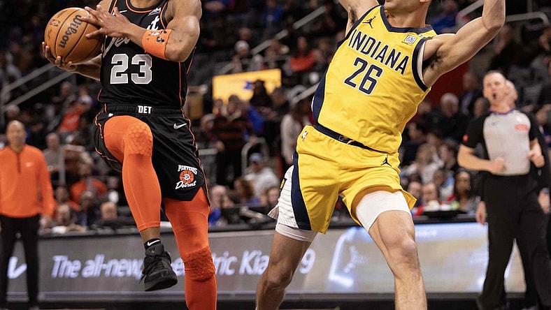Mar 20, 2024; Detroit, Michigan, USA; Detroit Pistons guard Jaden Ivey (23) drives to the basket next to Indiana Pacers guard Ben Sheppard (26) in the first half at Little Caesars Arena. Mandatory Credit: David Reginek-USA TODAY Sports