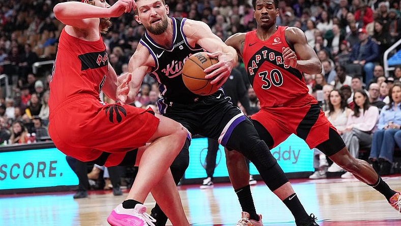 Mar 20, 2024; Toronto, Ontario, CAN; Sacramento Kings forward Domantas Sabonis (10) controls the ball as Toronto Raptors forward Kelly Olynyk (41) tries to defend during the second quarter at Scotiabank Arena. Mandatory Credit: Nick Turchiaro-USA TODAY Sports