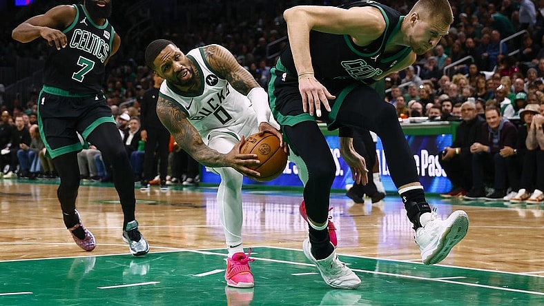 Mar 20, 2024; Boston, Massachusetts, USA; Milwaukee Bucks guard Damian Lillard (0) runs into the back of Boston Celtics center Kristaps Porzingis (8) during the second quarter at TD Garden. Mandatory Credit: Winslow Townson-USA TODAY Sports