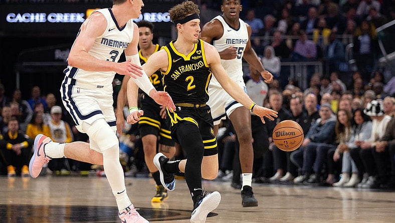 Mar 20, 2024; San Francisco, California, USA; Golden State Warriors guard Brandin Podziemski (2) drives between Memphis Grizzlies forward Jake LaRavia (3) and center Trey Jemison (55) during the first quarter at Chase Center. Mandatory Credit: D. Ross Cameron-USA TODAY Sports