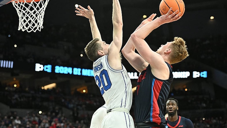 Mar 21, 2024; Omaha, NE, USA; Duquesne Dukes forward Jakub Necas (7) shoots against Brigham Young Cougars guard Spencer Johnson (20) in the first half during the first round of the NCAA Tournament at CHI Health Center Omaha. Mandatory Credit: Steven Branscombe-USA TODAY Sports