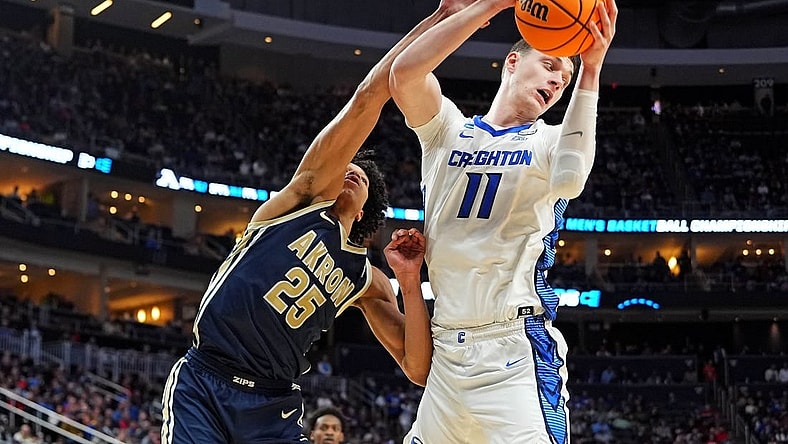 Mar 21, 2024; Pittsburgh, PA, USA; Creighton Bluejays center Ryan Kalkbrenner (11) grabs a rebound against Akron Zips forward Enrique Freeman (25) during the second half in the first round of the 2024 NCAA Tournament at PPG Paints Arena. Mandatory Credit: Gregory Fisher-USA TODAY Sports