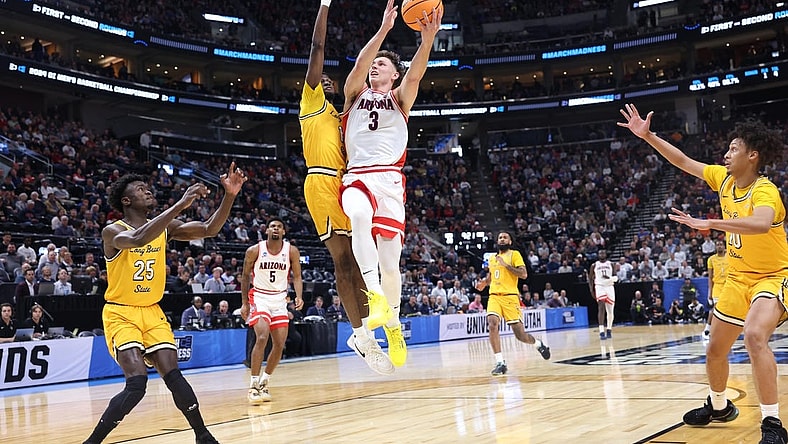 Mar 21, 2024; Salt Lake City, UT, USA; Arizona Wildcats guard Pelle Larsson (3) drives to the net against Long Beach State 49ers forward Amari Stroud (1) during the first half in the first round of the 2024 NCAA Tournament at Vivint Smart Home Arena-Delta Center. Mandatory Credit: Rob Gray-USA TODAY Sports