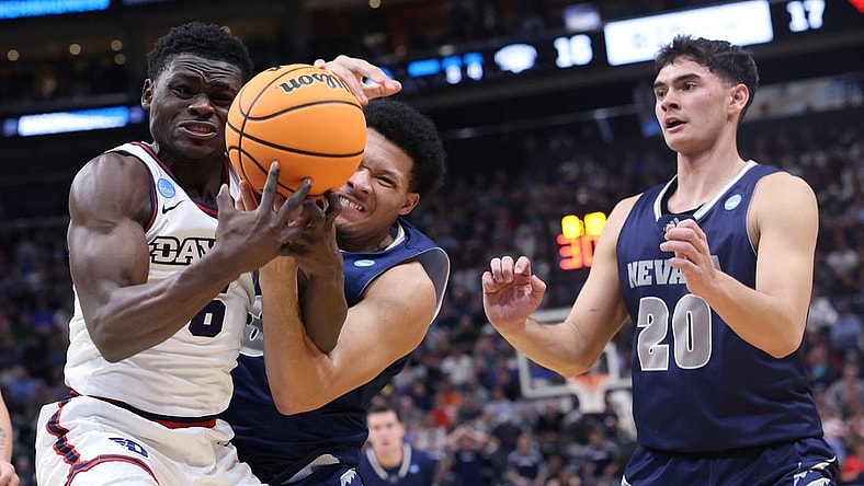 Mar 21, 2024; Salt Lake City, UT, USA; Dayton Flyers guard Enoch Cheeks (6) battles for the ball against  Nevada Wolf Pack forward Tylan Pope (33)during the first half in the first round of the 2024 NCAA Tournament at Vivint Smart Home Arena-Delta Center. Mandatory Credit: Rob Gray-USA TODAY Sports