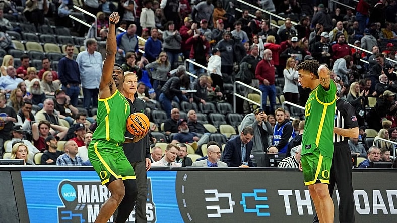 Mar 21, 2024; Pittsburgh, PA, USA; Oregon Ducks center N'Faly Dante (1) and guard Jadrian Tracey (22) celebrate with head coach Dana Altman after beating the South Carolina Gamecocks in the first round of the 2024 NCAA Tournament at PPG Paints Arena. Mandatory Credit: Gregory Fisher-USA TODAY Sports
