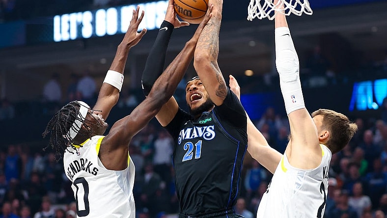 Mar 21, 2024; Dallas, Texas, USA;  Dallas Mavericks center Daniel Gafford (21) and Utah Jazz forward Taylor Hendricks (0) go for the ball during the first half at American Airlines Center. Mandatory Credit: Kevin Jairaj-USA TODAY Sports