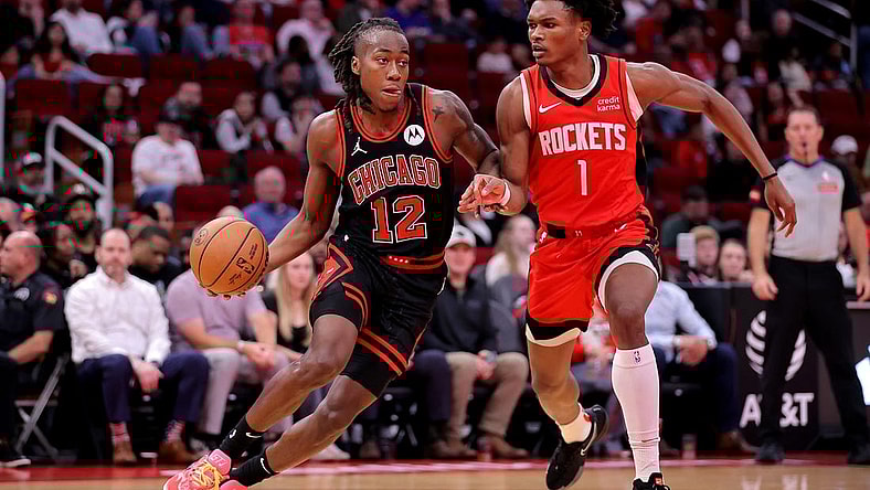 Mar 21, 2024; Houston, Texas, USA; Chicago Bulls guard Ayo Dosunmu (12) handles the ball against Houston Rockets forward Amen Thompson (1) during the second quarter at Toyota Center. Mandatory Credit: Erik Williams-USA TODAY Sports