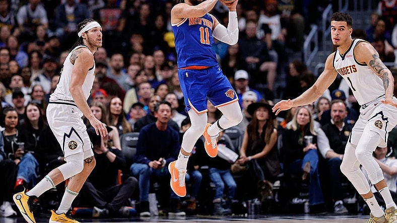 Mar 21, 2024; Denver, Colorado, USA; New York Knicks guard Jalen Brunson (11) controls the ball as Denver Nuggets forward Aaron Gordon (50) and ]forward Michael Porter Jr. (1) defend in the first quarter at Ball Arena. Mandatory Credit: Isaiah J. Downing-USA TODAY Sports