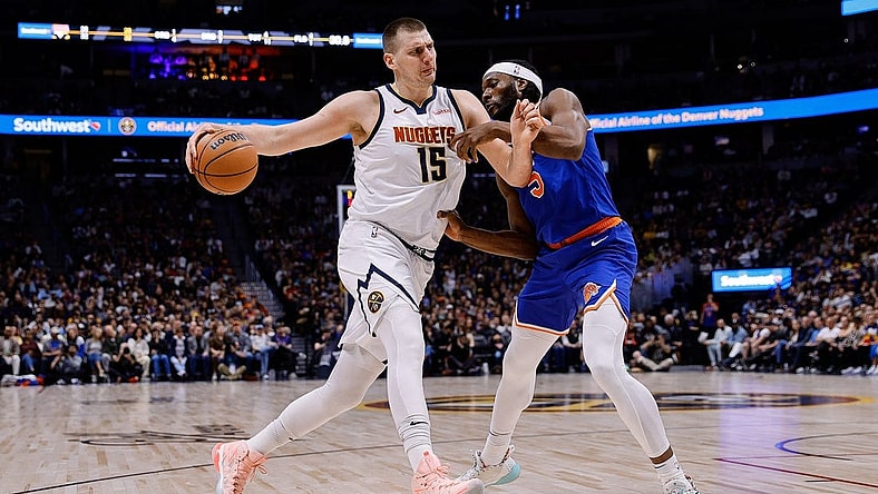 Mar 21, 2024; Denver, Colorado, USA; Denver Nuggets center Nikola Jokic (15) controls the ball as New York Knicks forward Precious Achiuwa (5) guards in the first quarter at Ball Arena. Mandatory Credit: Isaiah J. Downing-USA TODAY Sports