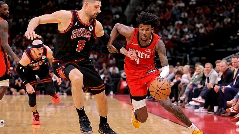 Mar 21, 2024; Houston, Texas, USA; Houston Rockets guard Jalen Green (4) handles the ball against Chicago Bulls center Nikola Vucevic (9) during the fourth quarter at Toyota Center. Mandatory Credit: Erik Williams-USA TODAY Sports