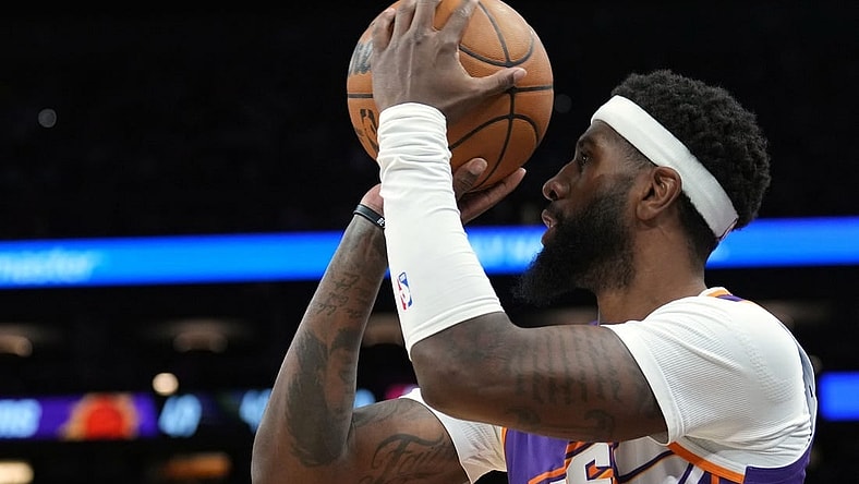 Mar 21, 2024; Phoenix, Arizona, USA; Phoenix Suns forward Royce O'Neale (00) shoots against the Atlanta Hawks during the first half at Footprint Center. Mandatory Credit: Joe Camporeale-USA TODAY Sports