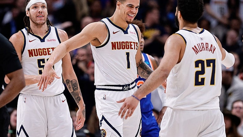Mar 21, 2024; Denver, Colorado, USA; Denver Nuggets forward Michael Porter Jr. (1) reacts with guard Jamal Murray (27) ahead of forward Aaron Gordon (50) in the fourth quarter against the New York Knicks at Ball Arena. Mandatory Credit: Isaiah J. Downing-USA TODAY Sports
