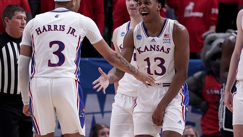 Mar 21, 2024; Salt Lake City, UT, USA; Kansas Jayhawks guard Elmarko Jackson (13) celebrates with guard Dajuan Harris Jr. (3) during the second half in the first round of the 2024 NCAA Tournament against the Samford Bulldogs at Vivint Smart Home Arena-Delta Center. Mandatory Credit: Gabriel Mayberry-USA TODAY Sports
