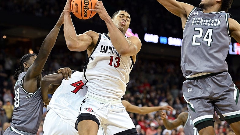 Mar 22, 2024; Spokane, WA, USA; San Diego State Aztecs forward Jaedon LeDee (13) rebounds the ball against UAB Blazers guard Efrem Johnson (24)  during the second half in the first round of the 2024 NCAA Tournament at Spokane Veterans Memorial Arena. Mandatory Credit: James Snook-USA TODAY Sports