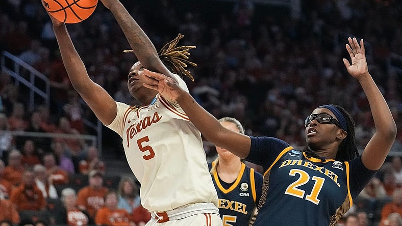 First round: Texas Longhorns forward DeYona Gaston (5) snares a rebound in front of Drexel Dragons forward Jasmine Valentine (21). The Longhorns won 82-42.