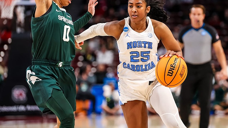 Mar 22, 2024; Columbia, SC, USA; North Carolina Tar Heels guard Deja Kelly (25) drives around Michigan State Spartans guard DeeDee Hagemann (0) in the second half at Colonial Life Arena. Mandatory Credit: Jeff Blake-USA TODAY Sports