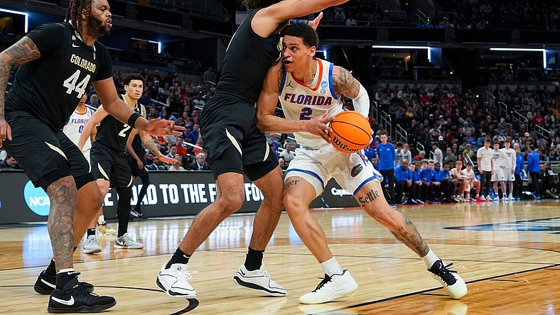 Florida Gators guard Riley Kugel (2) drives the lane against the Colorado Buffaloes on Friday, March 22, 2024, during the first round of the NCAA Men’s Basketball Tournament at Gainbridge Fieldhouse in Indianapolis. Florida Gators and Colorado Buffaloes are tied 45-45 at halftime.