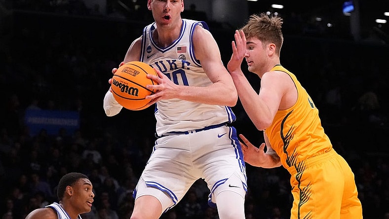 Mar 22, 2024; Brooklyn, NY, USA; Duke Blue Devils center Kyle Filipowski (30) grabs a rebound against the Vermont Catamounts in the first round of the 2024 NCAA Tournament at the Barclays Center. Mandatory Credit: Robert Deutsch-USA TODAY Sports