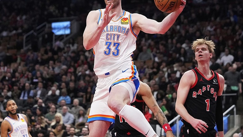 Mar 22, 2024; Toronto, Ontario, CAN; Oklahoma City Thunder forward Gordon Hayward (33) goes to pass the ball as Toronto Raptors guard Gradey Dick (1) looks on during the first half at Scotiabank Arena. Mandatory Credit: John E. Sokolowski-USA TODAY Sports