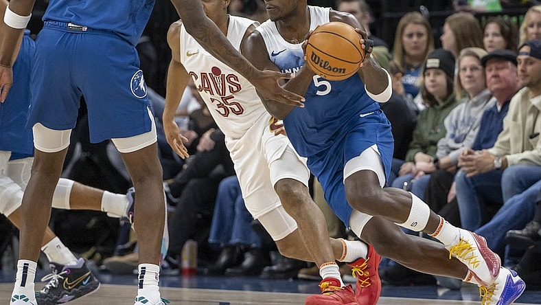 Mar 22, 2024; Minneapolis, Minnesota, USA; Minnesota Timberwolves guard Anthony Edwards (5) receives the ball from Minnesota Timberwolves center Naz Reid (11) against the Cleveland Cavaliers in the first half at Target Center. Mandatory Credit: Jesse Johnson-USA TODAY Sports