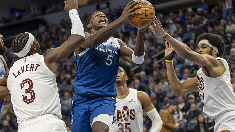 Mar 22, 2024; Minneapolis, Minnesota, USA; Minnesota Timberwolves guard Anthony Edwards (5) drives to the basket past Cleveland Cavaliers center Jarrett Allen (31) and Cleveland Cavaliers guard Caris LeVert (3) in the second half at Target Center. Mandatory Credit: Jesse Johnson-USA TODAY Sports