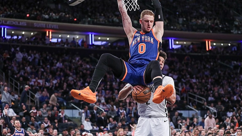 Mar 23, 2024; New York, New York, USA;  New York Knicks guard Donte DiVincenzo (0) dunks in front of Brooklyn Nets forward Cameron Johnson (2) in the fourth quarter at Madison Square Garden. Mandatory Credit: Wendell Cruz-USA TODAY Sports