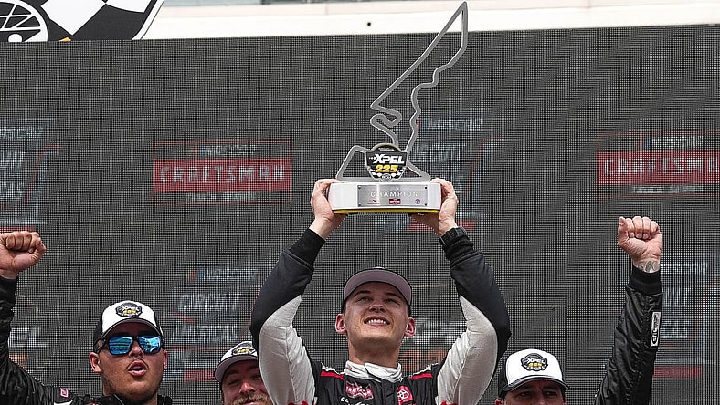 Corey Heim (11) holds up the trophy after wining the NASCAR Craftsman Truck Series Xpel 225 at the Circuit of the Americas on Saturday, March 23, 2024 in Austin.