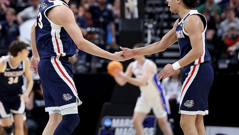 Mar 23, 2024; Salt Lake City, UT, USA; Gonzaga Bulldogs forward Ben Gregg (33) and guard Ryan Nembhard (0) celebrate during the second half in the second round of the 2024 NCAA Tournament against the Kansas Jayhawks at Vivint Smart Home Arena-Delta Center. Mandatory Credit: Rob Gray-USA TODAY Sports