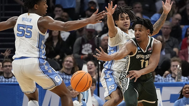 March 23, 2024, Charlotte, NC, USA; Michigan State Spartans guard A.J. Hoggard (11) passes away from North Carolina Tar Heels forward Harrison Ingram (55) and North Carolina Tar Heels guard Elliot Cadeau (2)  in the second round of the 2024 NCAA Tournament at the Spectrum Center. Mandatory Credit: Bob Donnan-USA TODAY Sports