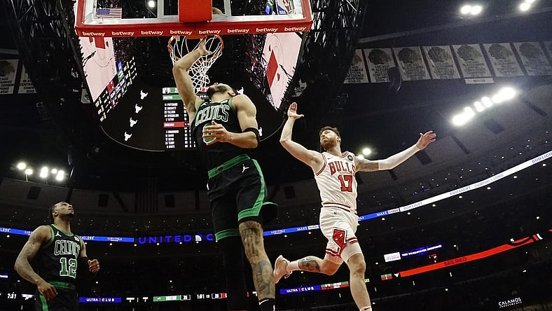 Mar 23, 2024; Chicago, Illinois, USA; Boston Celtics forward Jayson Tatum (0) scores on Chicago Bulls forward Onuralp Bitim (17) during the first quarter at United Center. Mandatory Credit: David Banks-USA TODAY Sports
