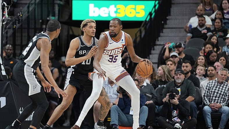 Mar 23, 2024; San Antonio, Texas, USA;  Phoenix Suns forward Kevin Durant (35) backs in against San Antonio Spurs forward Jeremy Sochan (10) in the first half at Frost Bank Center. Mandatory Credit: Daniel Dunn-USA TODAY Sports