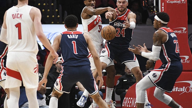 Mar 23, 2024; Washington, District of Columbia, USA;  Toronto Raptors guard Ochai Agbaji (30) and Washington Wizards forward Corey Kispert (24) leap for a loose ball during the first half at Capital One Arena. Mandatory Credit: Tommy Gilligan-USA TODAY Sports