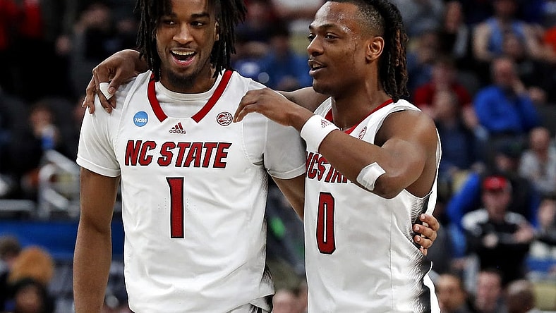 Mar 23, 2024; Pittsburgh, PA, USA; North Carolina State Wolfpack guard Jayden Taylor (1) celebrates with guard DJ Horne (0) after beating the Oakland Golden Grizzlies in the second round of the 2024 NCAA Tournament at PPG Paints Arena. Mandatory Credit: Charles LeClaire-USA TODAY Sports